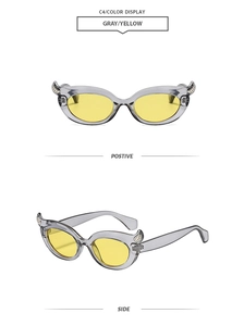 Front and side detail view of gray devil horn cat eye sunglasses with yellow lenses