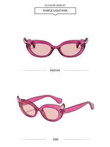 Detailed views of magenta cat-eye sunglasses with rhinestone devil horns and pink lenses