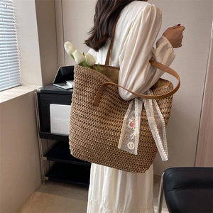 Large hand-woven straw tote bag with floral lace ribbon and brown leather straps