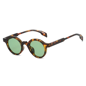 Retro oval tortoiseshell sunglasses with green lenses shown in a top-down view