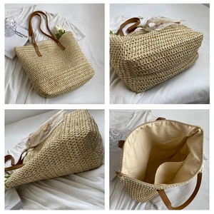 Handmade woven straw tote bag with brown leather handles and floral lace scarf detail