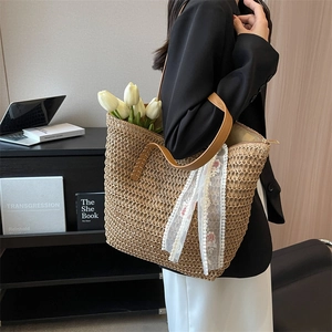 Handmade straw tote bag with brown leather straps and white floral lace embroidery