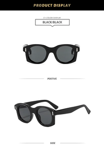 Détail des lunettes de soleil noires vintage avec rivets métalliques sur les branches