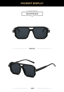 Detail view of black square double-bridge sunglasses with metallic hinge accents