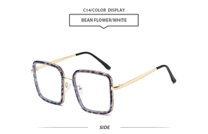 Vue latérale de lunettes de soleil carrées vintage avec monture fleurie et branches dorées