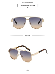 Detail of pilot sunglasses with golden metal frame and gray-brown gradient lenses