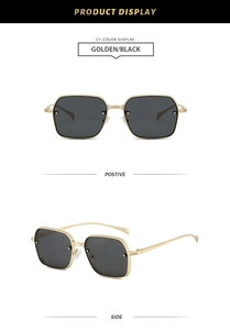 Détail de lunettes de soleil carrées en métal doré avec verres noirs et clous décoratifs