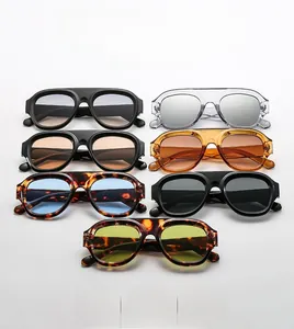 Flat lay of retro oversized sunglasses in black, tortoiseshell and clear color frames