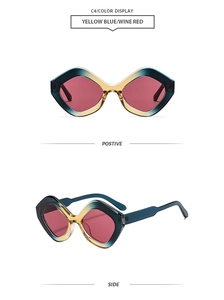 Detail view of wine red lenses and gradient yellow-blue geometric frames on sunglasses
