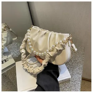 Detailed view of off-white ruched cloud bag with large pearl chain and soft leather texture