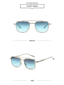 Detail view of silver metal double bridge sunglasses with gradient green lenses