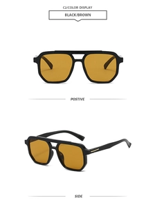 Detail view of vintage double-bridge aviator sunglasses with black frames and brown lenses