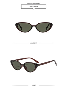 Detailed view of vintage cat-eye sunglasses in tea-colored frames with green lenses