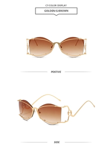Detail of golden butterfly rimless sunglasses with gradient brown lenses and hollow M design