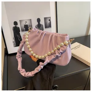Detail of lavender cloud bag with pleated PU leather texture and large pearl handle strap