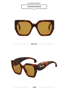Vue détaillée des lunettes de soleil léopard avec logo doré et verres marrons