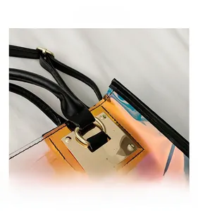 Detail view of laser PVC holographic handbag with gold hardware and black leather trim