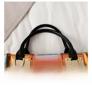 Detail of holographic PVC handbag with premium black handle and golden metal buckles