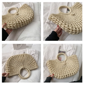 Detail of hollow-out woven straw beach bag featuring round handles and beige fabric lining