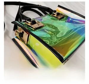 Detailed close-up of iridescent PVC bag with black leather trim and gold metal buckle