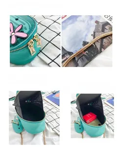 Detail view of green cactus-shaped PU handbag showing gold chain and zipper closure