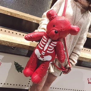 Detailed side view of the red leather bear backpack featuring a white skeleton bone pattern