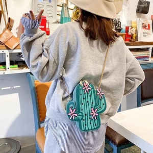 Close-up of green cactus-shaped PU crossbody bag with pink flowers and gold chain