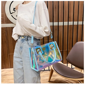 Close-up of holographic PVC tote bag with sky blue leather trim and golden hardware
