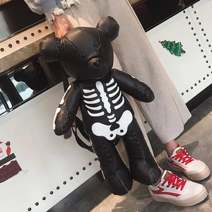 Detail of black pebbled leather bear backpack featuring white skeleton print and X-stitches