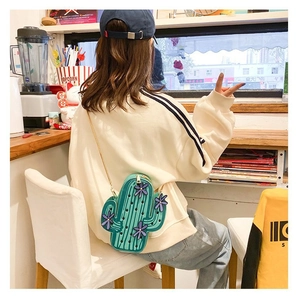Detailed close-up of a cactus shaped green PU leather crossbody bag with chain strap