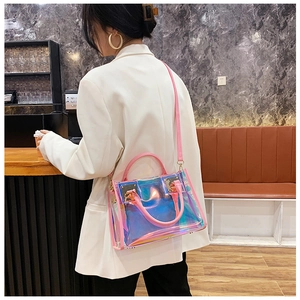 Detailed view of pink leather trim and laser PVC material on a transparent handbag