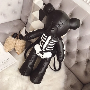 Detail of bear-shaped leather backpack with white skeleton print and sleek PU finish
