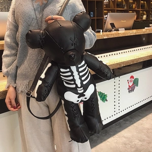 Detail of creative black leather bear backpack featuring white skeleton print and stitched eyes