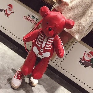 Detail of red bear leather backpack featuring white skeleton pattern and stylish straps