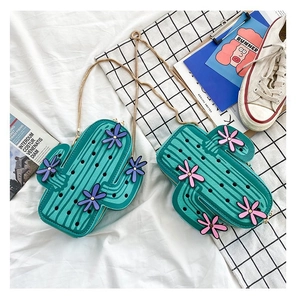 Detail of funny cactus-shaped PU leather crossbody bags with pink and purple flowers