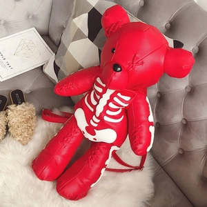 Detail showing red leather bear backpack with white skeleton print and red stitching