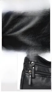 Close-up of premium black washed leather texture and metal zipper detail on women bag