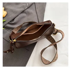 Vue détaillée du sac polochon marron avec bandoulière jacquard et poche interne