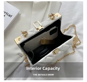 Internal view of a white quilted box bag showing space for phone and makeup