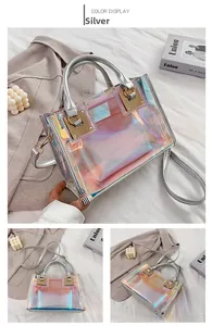 Detailed view of silver holographic PVC handbag with inner pouch and gold-tone hardware