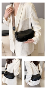 Détails du sac demi-lune noir avec finitions dorées et large bandoulière jacquard