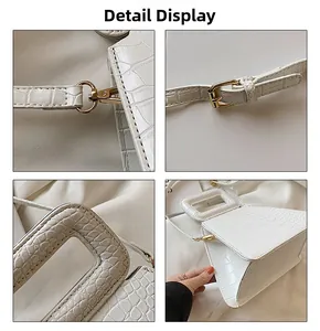 Detail shots of white crocodile pattern geometric bag with gold hardware and strap