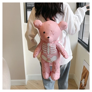 Pink bear leather backpack featuring skeleton print and cross strap details on model