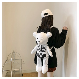 Detail view of gothic bear backpack with black skull print and white bandage accents