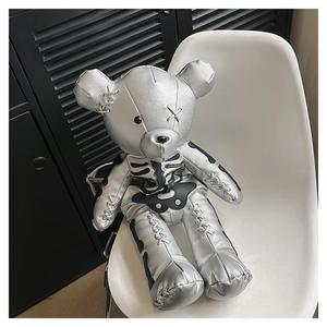 Detailed view of punk style silver leather bear backpack featuring black bone print details