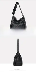 Close-up of a black washed leather handbag with multiple functional zipper pockets and strap