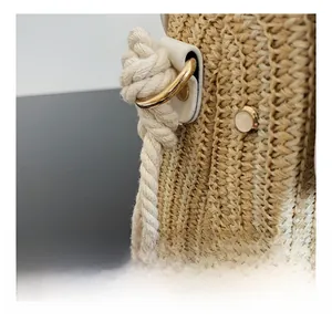 Macro detail of the woven texture with gold D-ring hardware and cotton rope strap on the bag