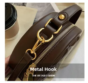 Macro detail of high-quality golden hardware hooks and leather texture on a brown handbag