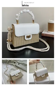 Detail of white pleated cloud handle and straw crossbody bag with golden clasp