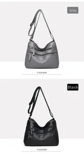 Detail view of the multi-zipper compartments on gray and black soft leather crossbody bags